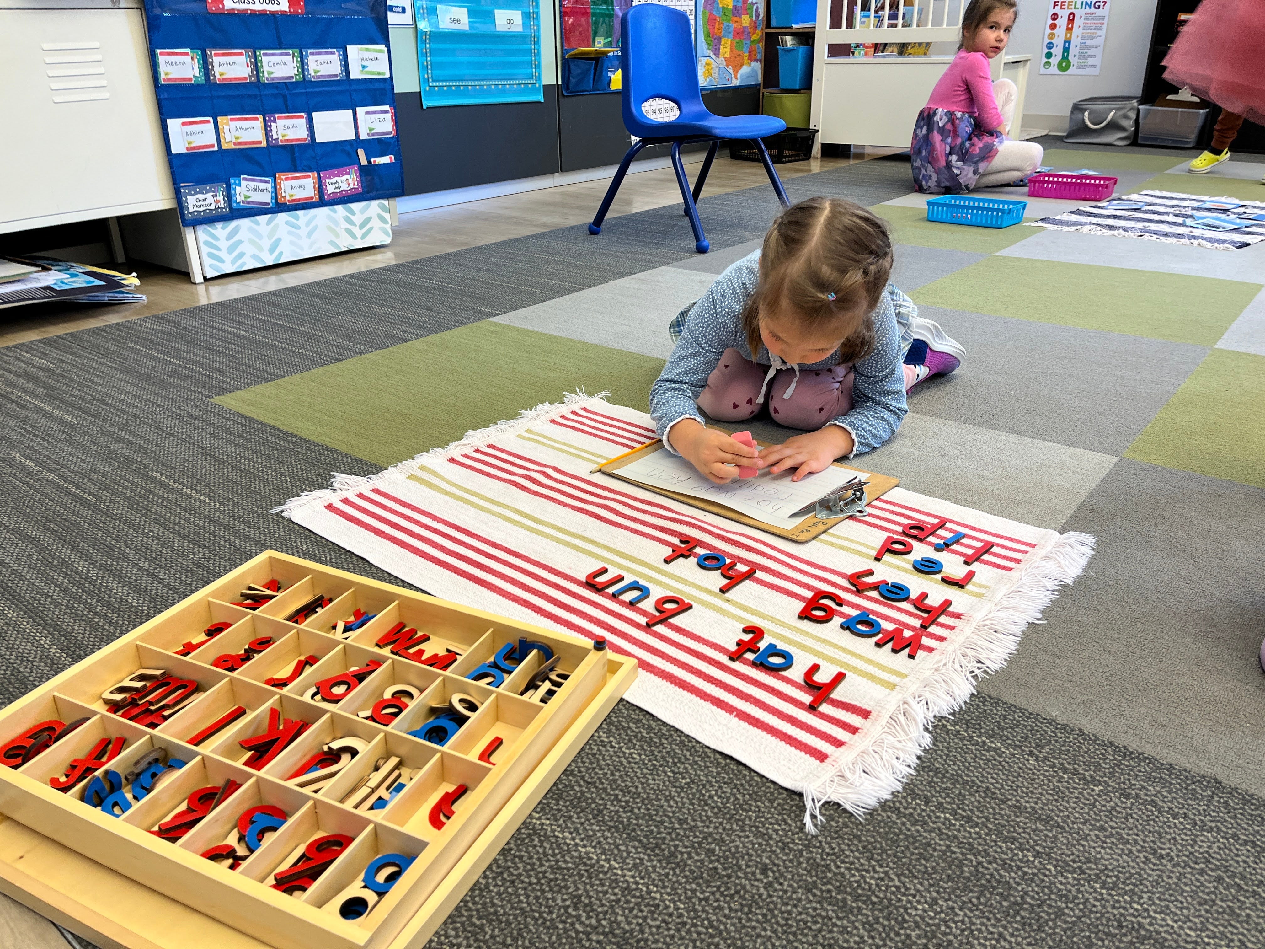 Child playing with educational toys on a classroom floor