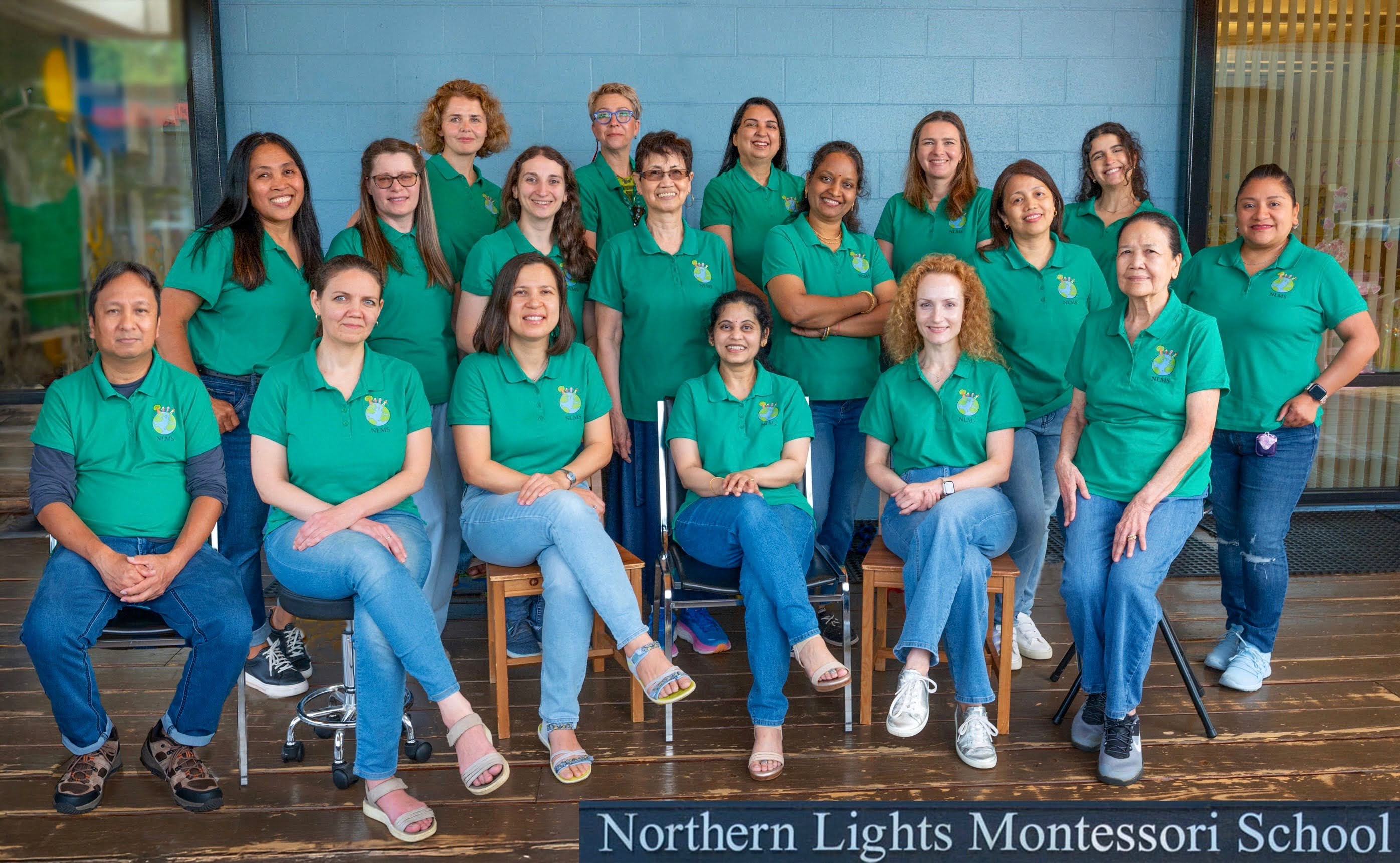 Group of people in green shirts posing for a photo at Northern Lights Montessori School