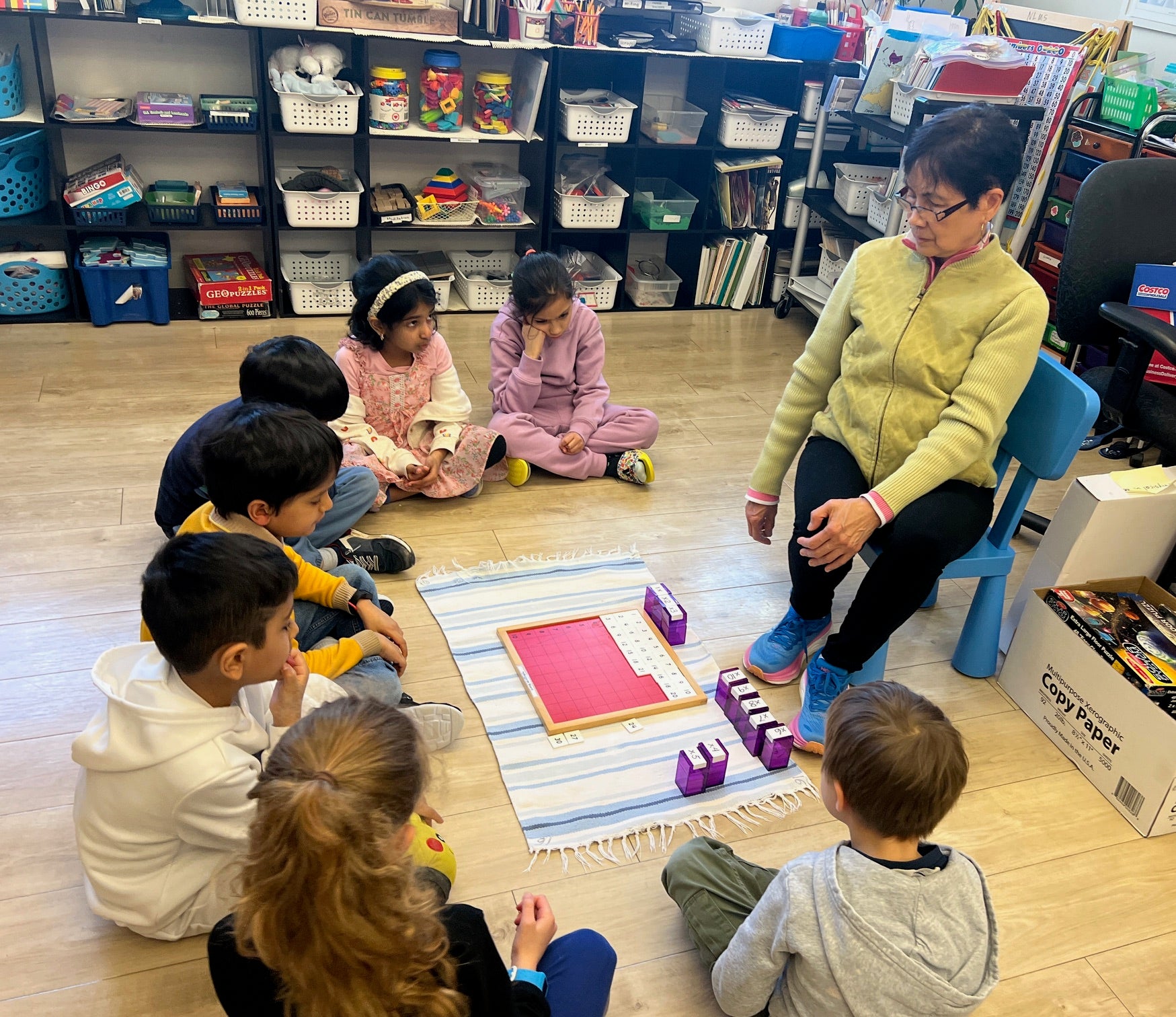 Teacher interacting with children in a classroom setting